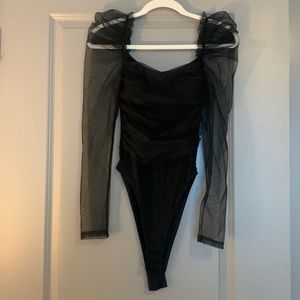 Women’s black bodysuit with sheer black puff sleeves